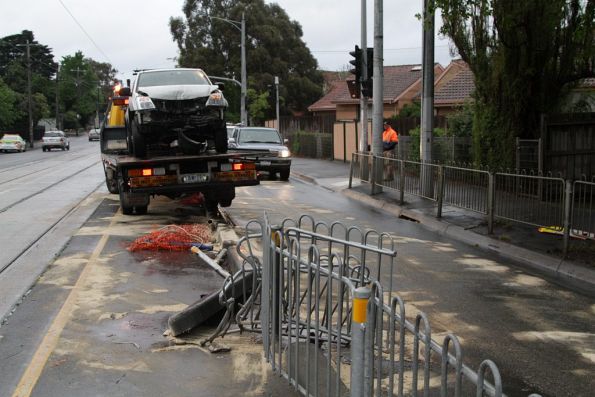 Sand covers the ground to absorb spilled oil, the fire brigade having attended