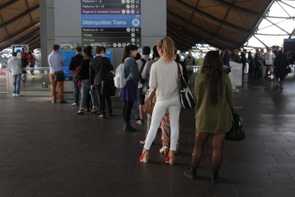 People still line up to top up their myki at Southern Cross Station 