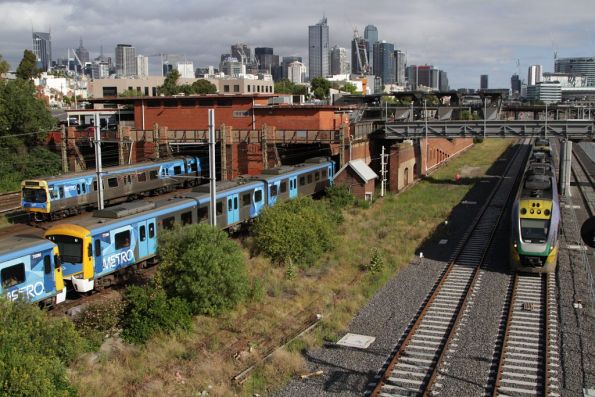 VLocity VL04 on a down Geelong train speeds past suburban trains at North Melbourne station