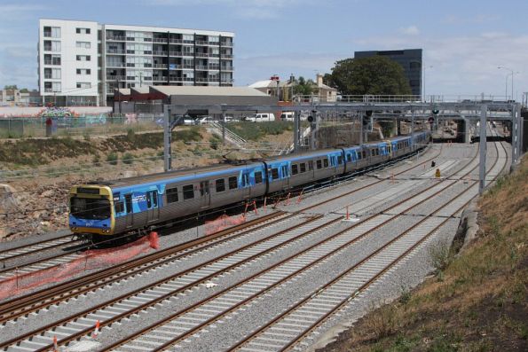 Up Werribee train passes the future RRL and realigned suburban tracks outside Footscray