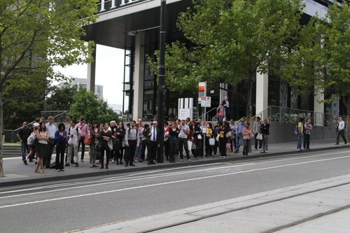 Hoards of passengers waiting outside Southern Cross for the bus to Fishermans Bend