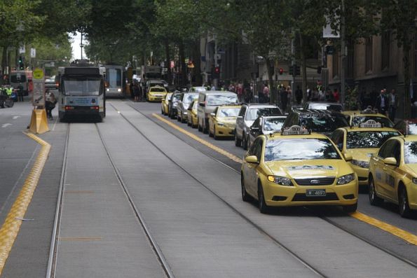 Another taxi driver on Collins Street undeterred by the new plastic kerbs along the tracks