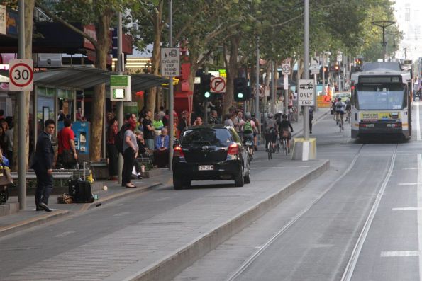 Queensland registered car driving north up the Swanston Street bike lane