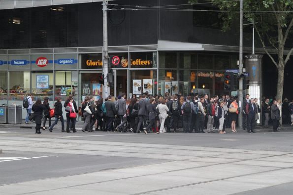 Citybound pedestrians queue back onto Spencer Street due to the narrow footpath on Collins Street