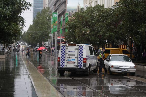 Police talk to a nuffy driver in the middle of the Bourke Street Mall