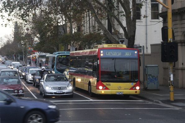 Queue of four citybound Transdev buses waiting to turn right from Hoddle Street into Victoria Parade