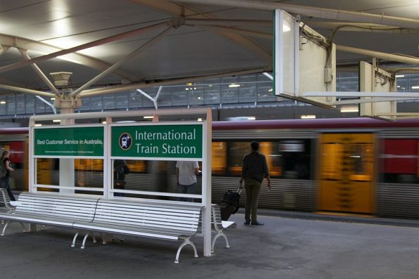 Waiting for a cross at International station, with a Domestic-bound service arriving in the other platform