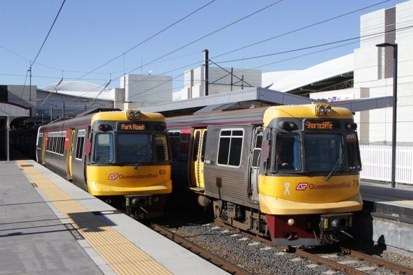 EMU78 passes EMU60 at South Brisbane station