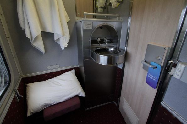 Washbasin and visitors seat inside a roomette carriage