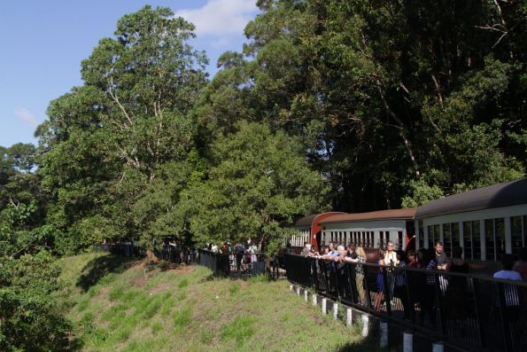 Passengers look out over Barron Falls from the station platform