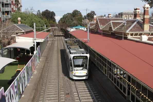 D2.5014 on a citybound route 96 service passes the former railway station buildings at South Melbourne