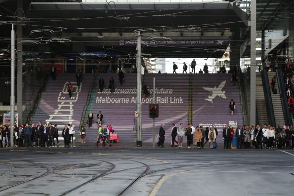 'Step towards the future Melbourne Airport Rail Link' propaganda on the main steps to the Bourke Street bridge at Southern Cross Station