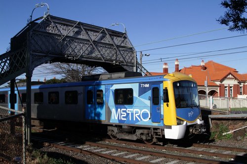 Siemens 774M on a down Craigieburn service, passing under a footbridge south of Moonee Ponds station