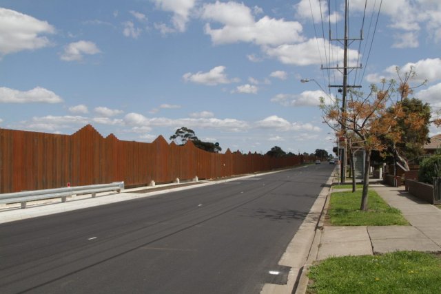 Steel noise walls line the railway parallel to Forrest Street