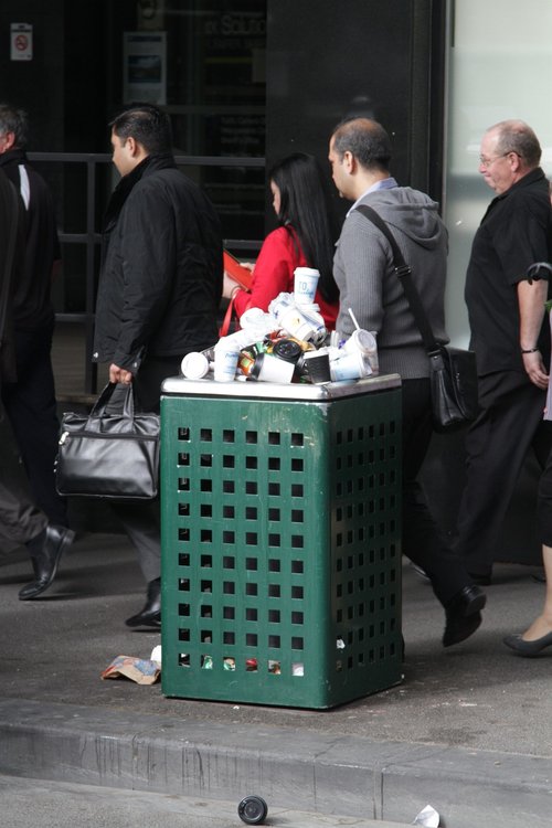 Rubbish bin overflowing with coffee cups outside Flagstaff station