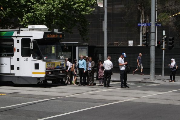 Passengers spill out of a 'safety' zone on Collins Street at William Street