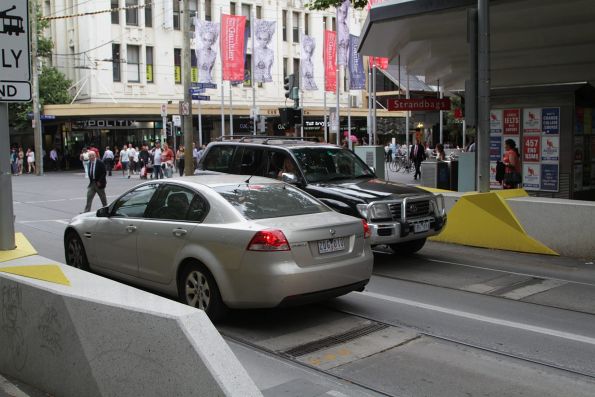 A confused motorist at the corner of Swanston and Bourke Street gets pulled up by an unmarked police car