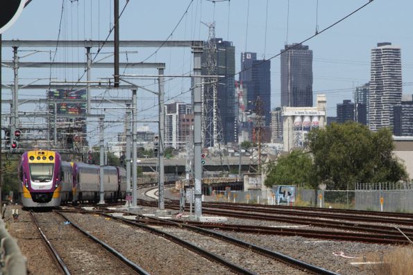 Up Geelong service on the suburban lines at South Kensington crosses onto the RRL tracks towards Southern Cross