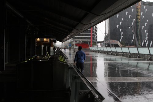 Pedestrians on the Bourke Street Bridge only have a narrow section of covered walkway 