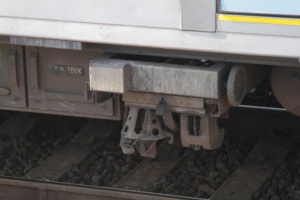 Emergency transition coupler beneath a Siemens train