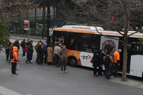 Passengers board a Fishermans Bend-bound bus at Southern Cross via both front and back doors