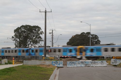 Siemens train passes through the closed Evans Road level crossing in Lynbrook