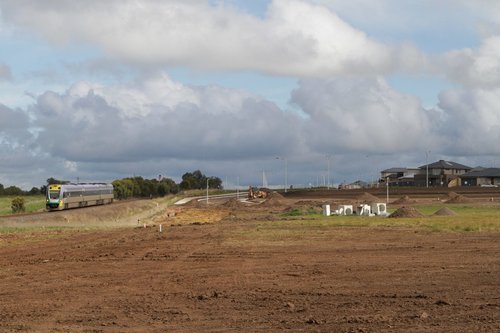 VLocity 3VL19 on a Melbourne-bound service passes new housing developments outside Waurn Ponds station