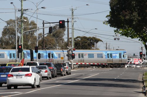 Alstom Comeng 669M crosses the soon to be removed Furlong Road level crossing at Ginifer