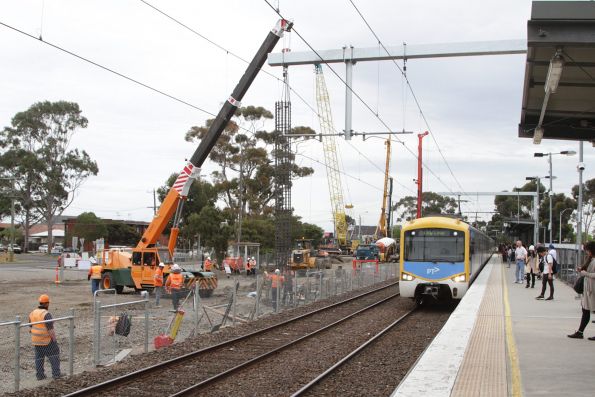 Citybound Sunbury service arrives into St Albans, with grade separation works underway on the opposite side