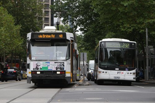 A2.261 on route 48 parallels Transdev bus #433 7833AO on a route 232 service along Collins Street