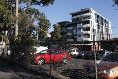 Six story high apartment block towers over Carnegie station