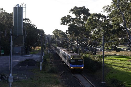 EDI Comeng on a down Cranbourne service passes the disused cement siding at Lyndhurst