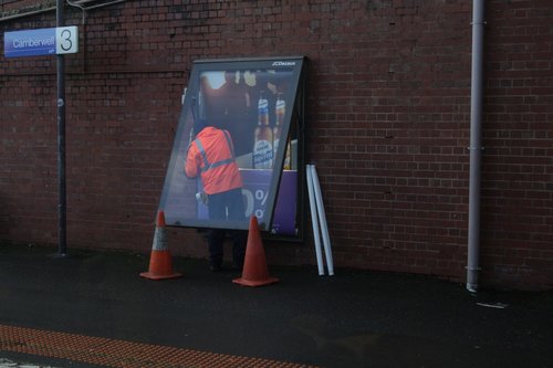 Changing over the advertisements at Camberwell station