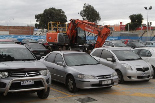 Hi-rail excavator parked in the Blackburn station's temporary replacement car park