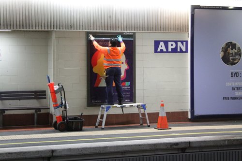 Changing over the advertising posters at Box Hill station