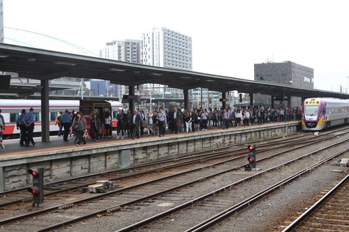 Stream of passengers exit their train at the north end of platform 3