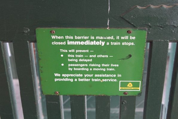 Metropolitan Transit-era 'when this barrier is manned, it will be closed immediately a train stops' sign