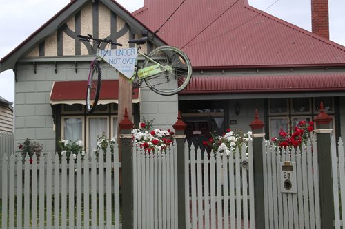 Bike with a 'Rail under not over' message on it, outside a house backing onto the railway at Carnegie