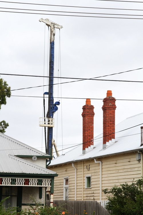 Piling rig visible over houses at Carnegie