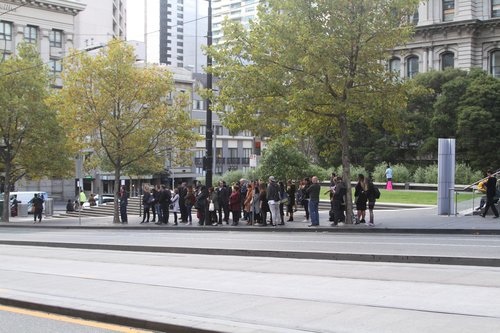 Passengers waiting at Collins and Spencer Street for a bus towards Fishermans Bend