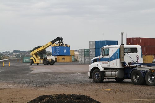 Reach stacker unloads containers from the train