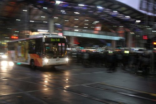 Transdev bus eastbound on Collins Street passes Southern Cross Station