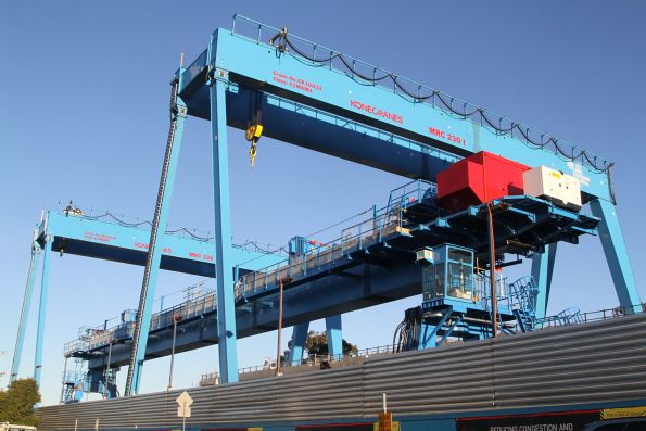 Two gantry cranes and the straddle carrier ready to go at Murrumbeena station