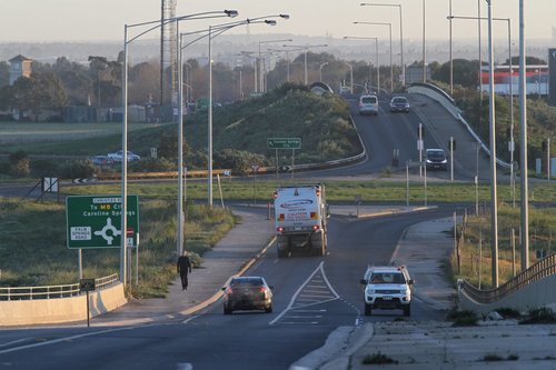 One hardy passenger walks along the narrow footpaths to reach Caroline Springs station 