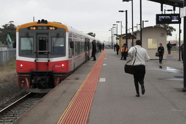 Passenger runs for the train at Deer Park station