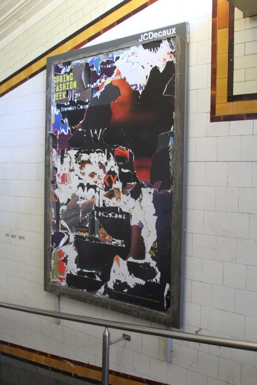 Tattered advertising posters in the Elizabeth Street subway at Flinders Street Station