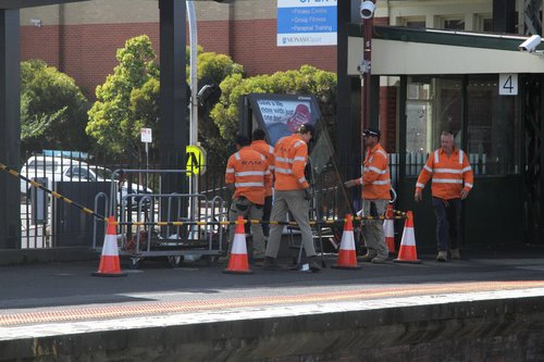 Contractors remove the JCDecaux advertising panels at Caulfield station