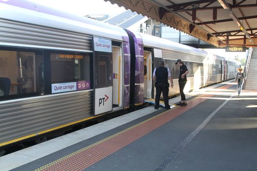 VLocity train conductor deploys the wheelchair ramp at Footscray station