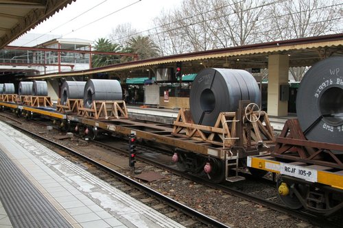 Coil steel wagons leading butterbox containers on the down Long Island steel train