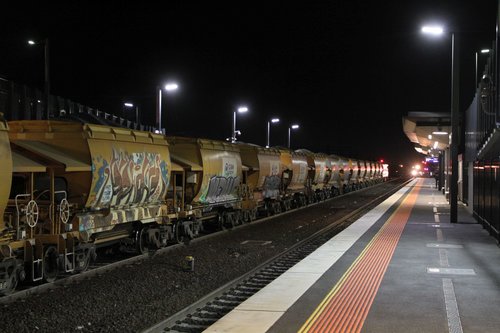 Down V/Line service arrives at Sunshine, as the up Apex train waits for a signal across to Brooklyn